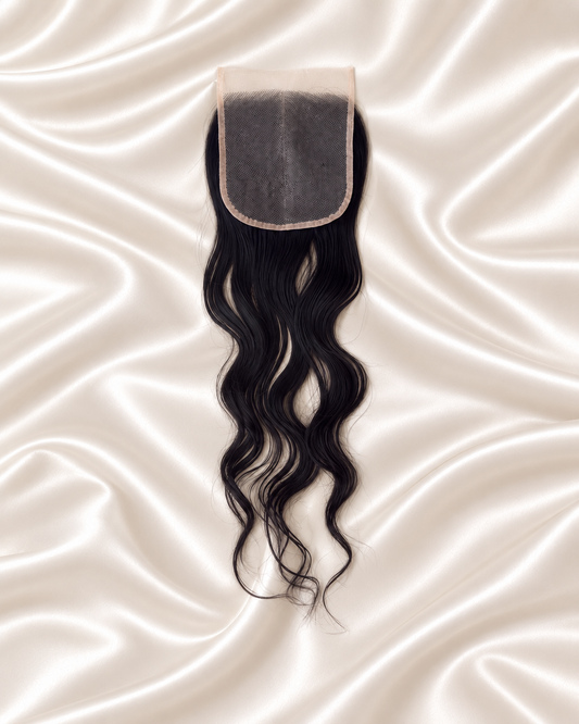 Raw Cambodian Wavy 5x5 HD lace closure on ivory satin backside.